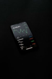 black background photo of cellphone with graphs - Image of Cryptocurrency Investing, "advanced crypt